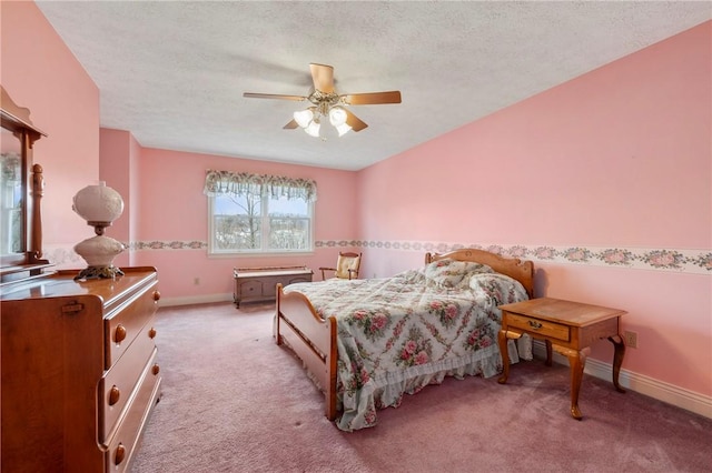 bedroom featuring ceiling fan, light colored carpet, and a textured ceiling