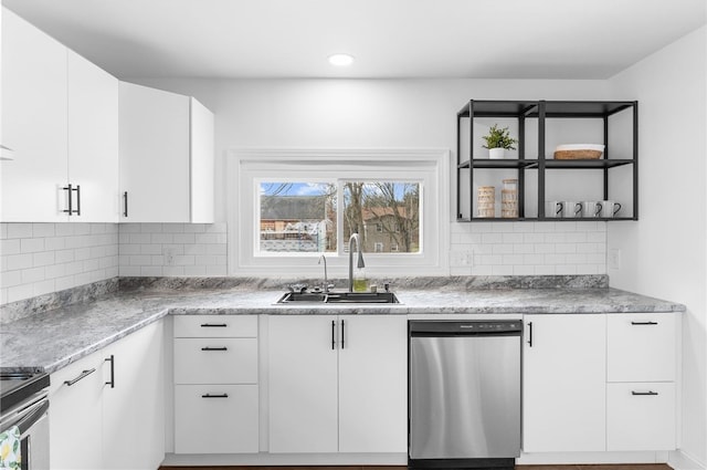 kitchen featuring appliances with stainless steel finishes, sink, white cabinets, and backsplash