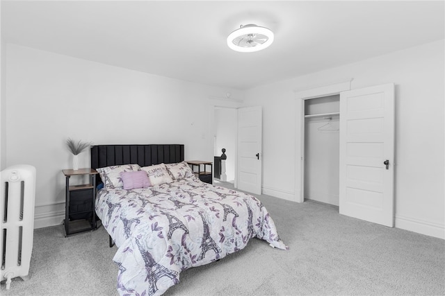 bedroom with a closet and light carpet