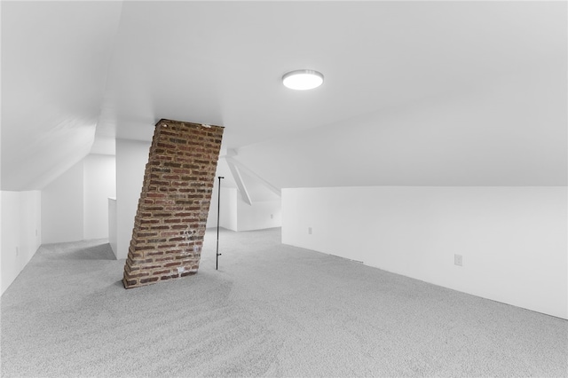 bonus room featuring light colored carpet and vaulted ceiling