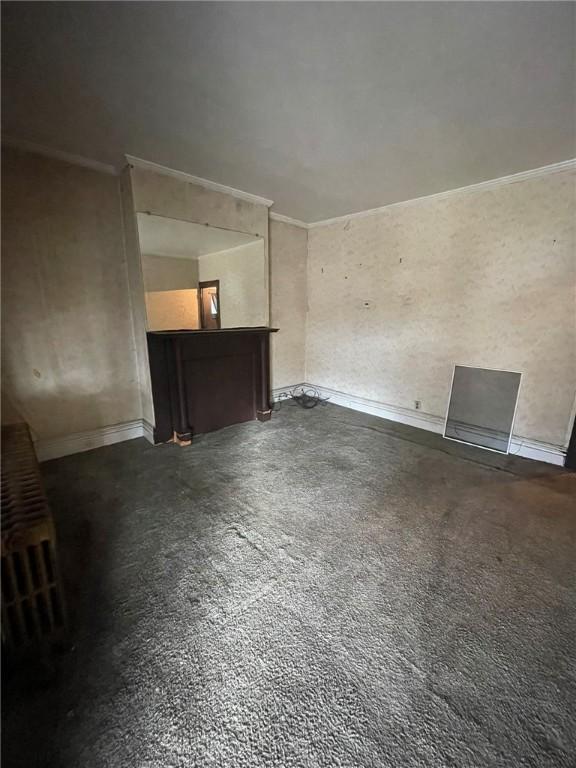 unfurnished living room with ornamental molding