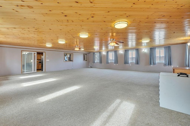 spare room featuring carpet floors and wood ceiling