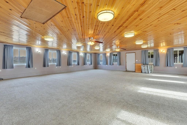 carpeted spare room with ceiling fan and wooden ceiling