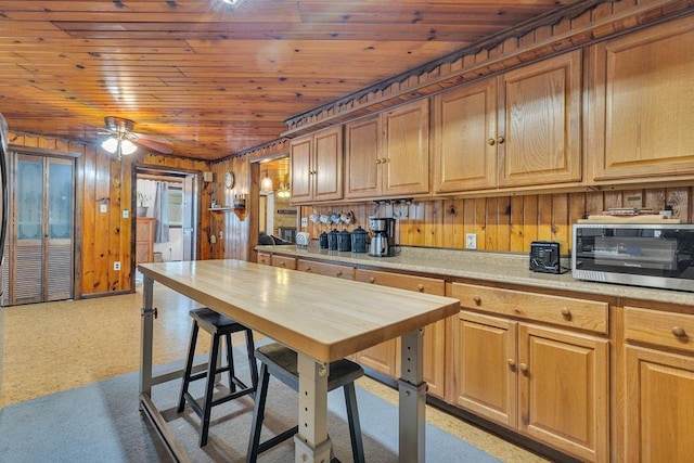 kitchen with wood ceiling and wooden walls