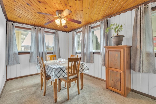 dining space with light colored carpet, wooden ceiling, and ceiling fan