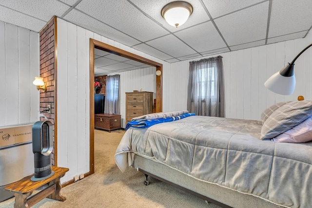 bedroom featuring light carpet and a drop ceiling