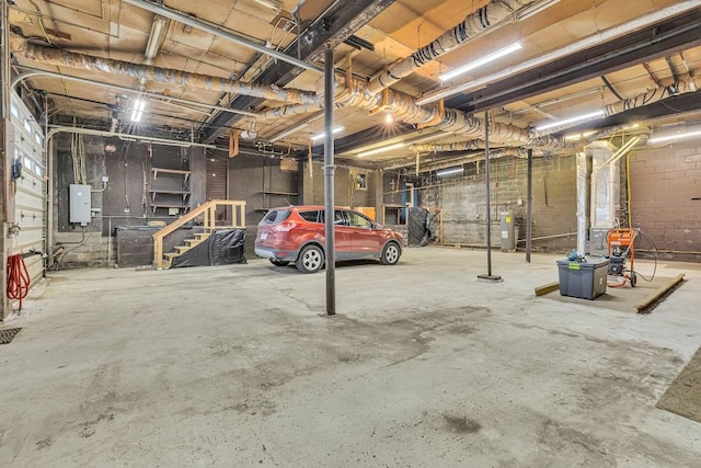 garage with electric panel and water heater