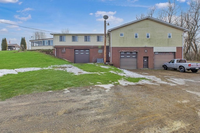 view of front of home with a garage and a front lawn