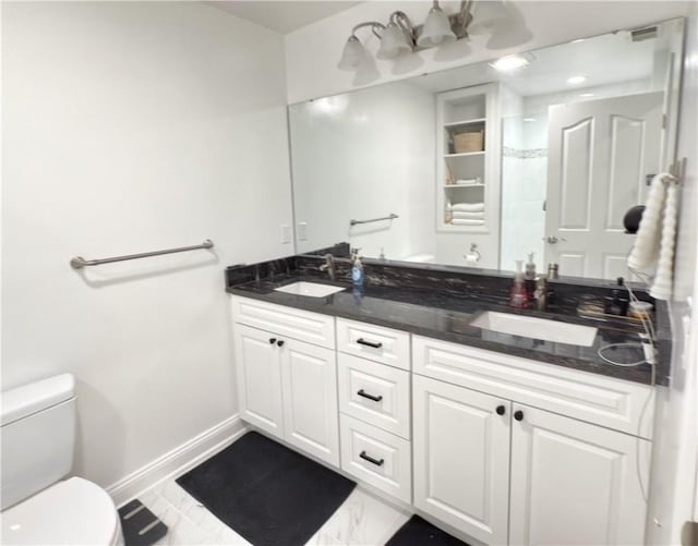 bathroom featuring vanity, a shower, and toilet