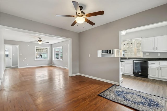 kitchen featuring black dishwasher, dark wood-type flooring, white cabinets, and ceiling fan