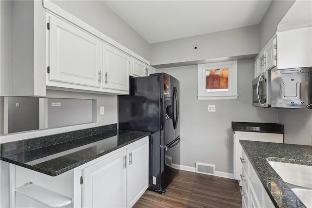 kitchen with dark wood-type flooring, sink, white cabinetry, black refrigerator with ice dispenser, and dark stone countertops