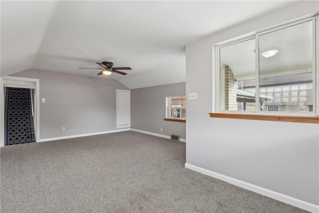 interior space featuring vaulted ceiling, carpet floors, and ceiling fan