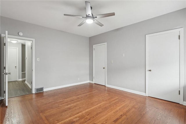 unfurnished bedroom with wood-type flooring and ceiling fan