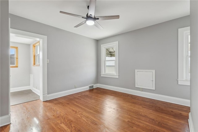 empty room featuring ceiling fan and light hardwood / wood-style floors