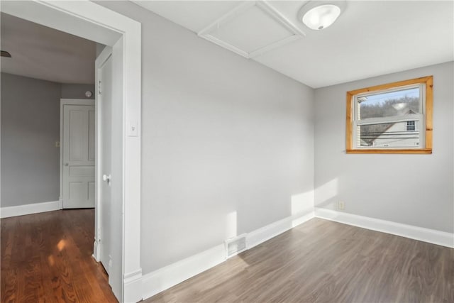 unfurnished room with dark hardwood / wood-style floors