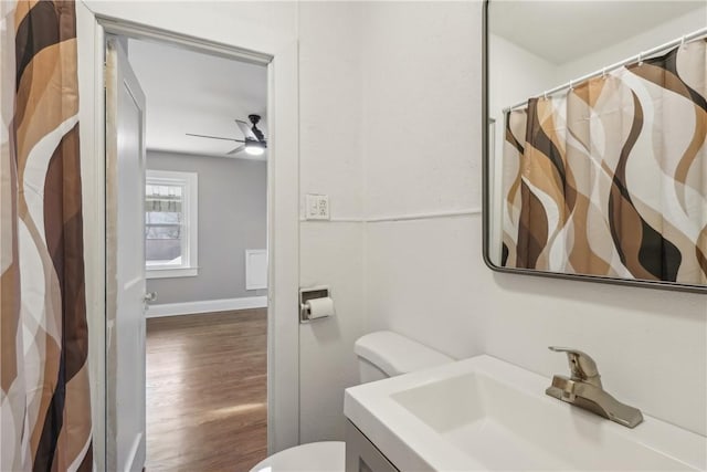 bathroom with ceiling fan, vanity, toilet, and wood-type flooring