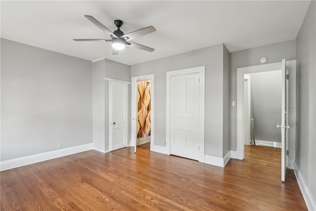 unfurnished bedroom with hardwood / wood-style floors and ceiling fan