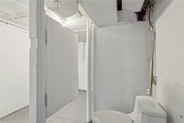 bathroom featuring toilet and concrete flooring