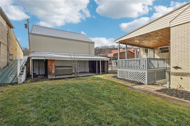 view of yard featuring a wooden deck and a hot tub