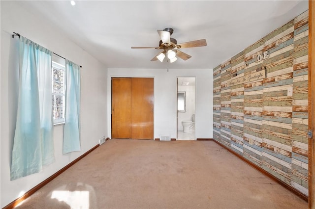 carpeted empty room with ceiling fan