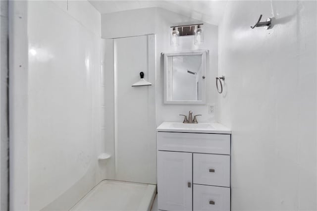 bathroom with vanity and a shower