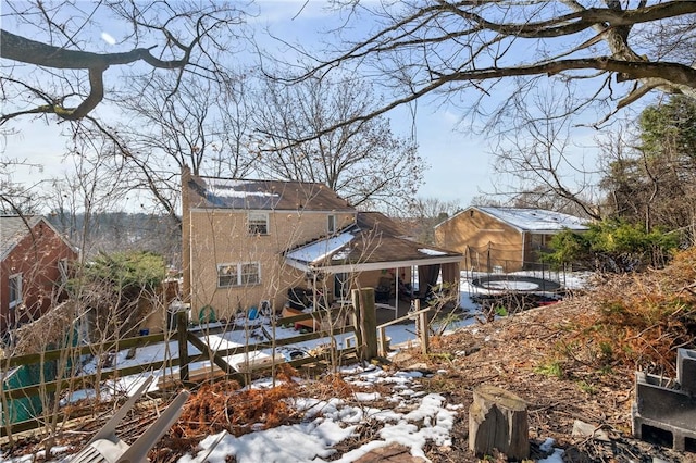 view of snow covered rear of property