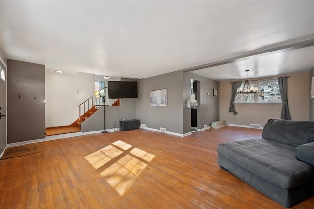 living room featuring an inviting chandelier and wood-type flooring