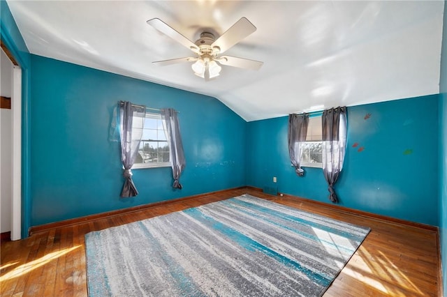 interior space featuring hardwood / wood-style floors, vaulted ceiling, and ceiling fan