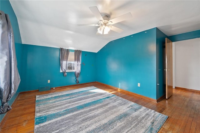 interior space with hardwood / wood-style flooring, vaulted ceiling, and ceiling fan