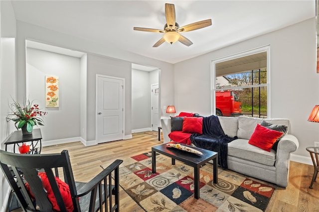 living room featuring ceiling fan and light wood-type flooring