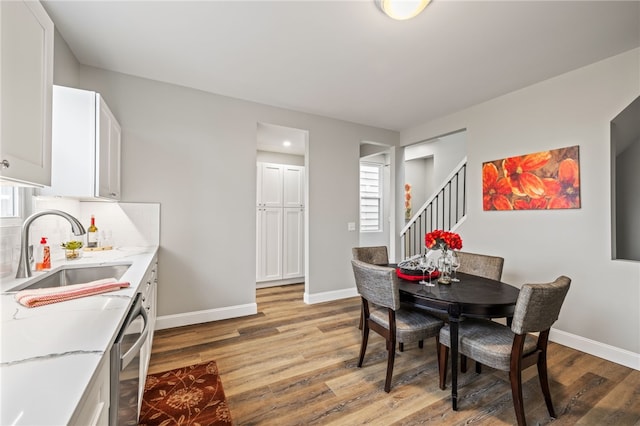 dining area with sink and light wood-type flooring