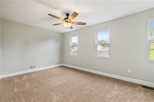 carpeted spare room with ceiling fan