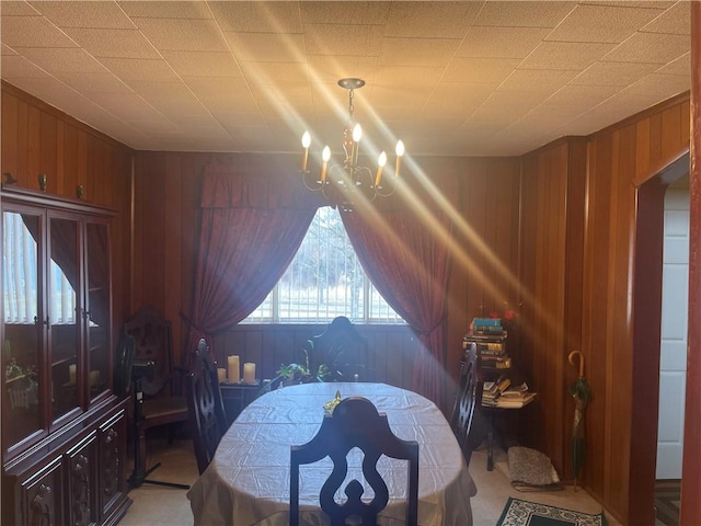 bedroom with a chandelier and wood walls