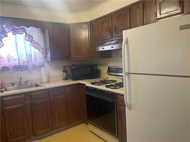 kitchen featuring white refrigerator, dark brown cabinetry, sink, and range with gas cooktop