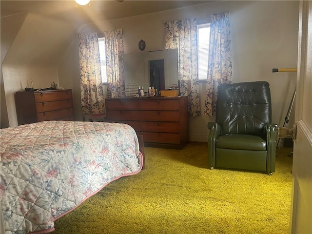 bedroom with multiple windows, vaulted ceiling, and carpet flooring