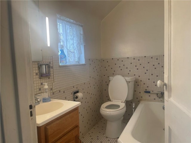 bathroom with toilet, tile walls, vanity, a bathtub, and tile patterned flooring