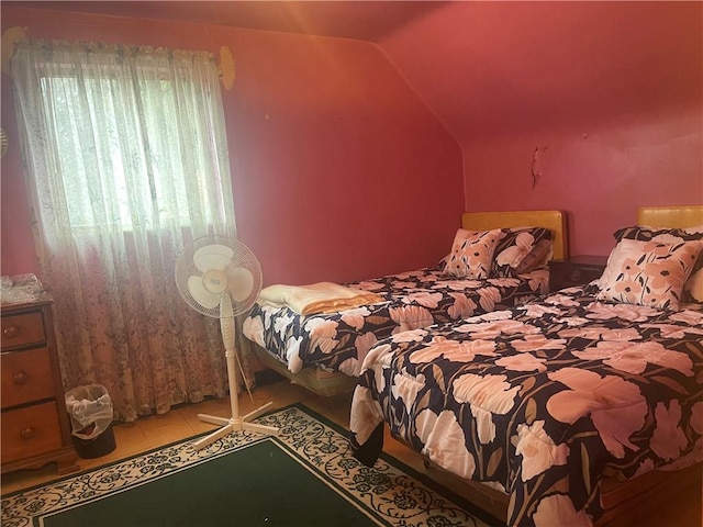 tiled bedroom featuring vaulted ceiling