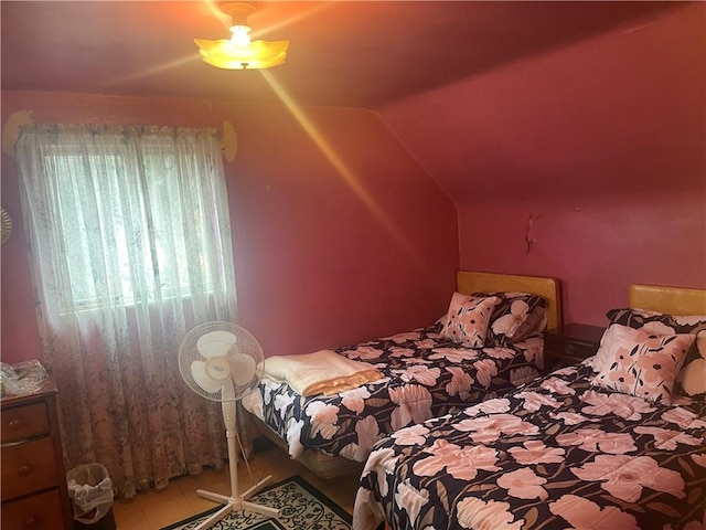 bedroom with lofted ceiling and tile patterned flooring