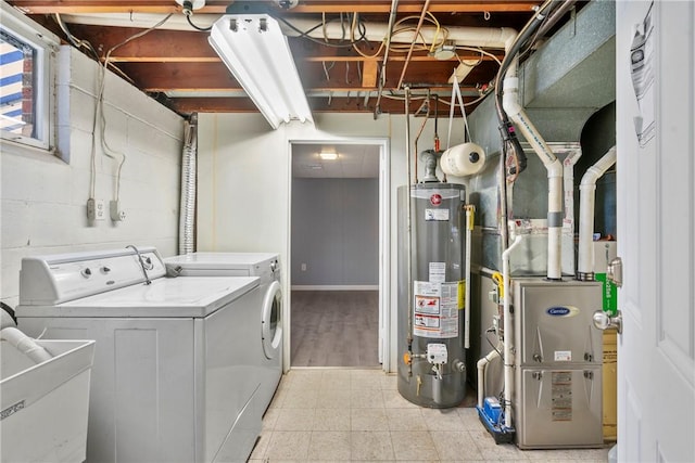 washroom featuring washer and clothes dryer, sink, and gas water heater