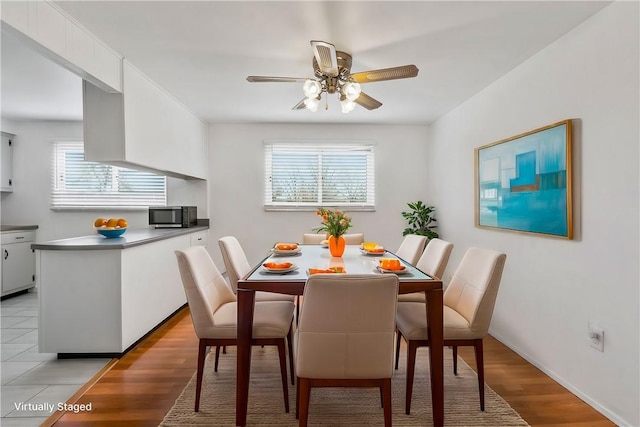 dining space with ceiling fan, plenty of natural light, and light hardwood / wood-style flooring