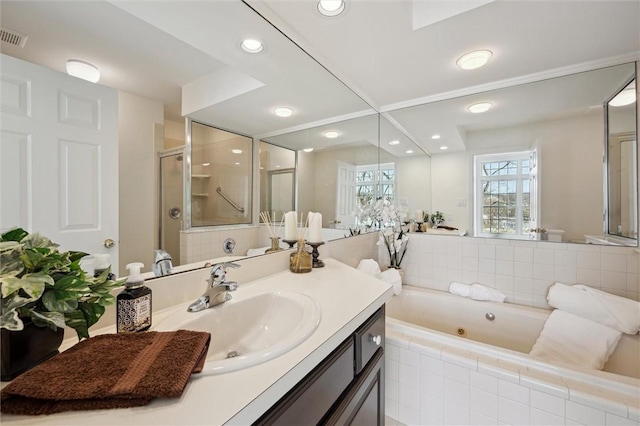 bathroom with vanity and independent shower and bath