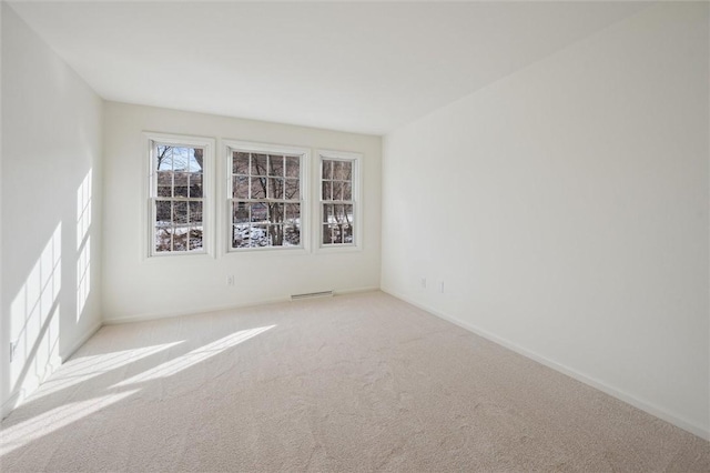 unfurnished room featuring light colored carpet