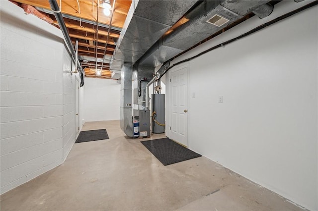 basement with water heater and heating unit