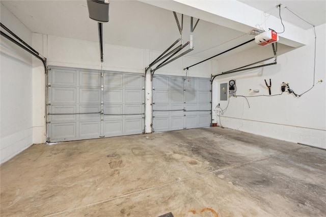 garage with a garage door opener and electric panel