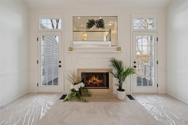 entryway featuring carpet flooring and a fireplace