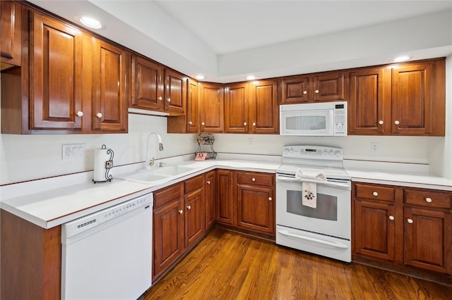 kitchen featuring sink, white appliances, and dark hardwood / wood-style floors