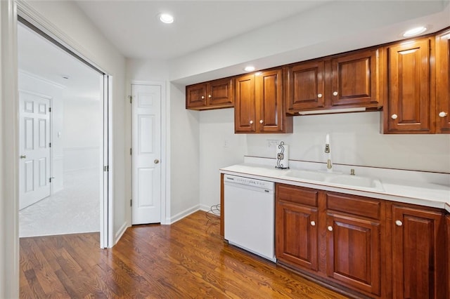 kitchen with white dishwasher, sink, and dark hardwood / wood-style flooring