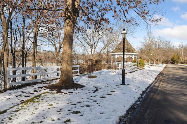 yard layered in snow with a gazebo