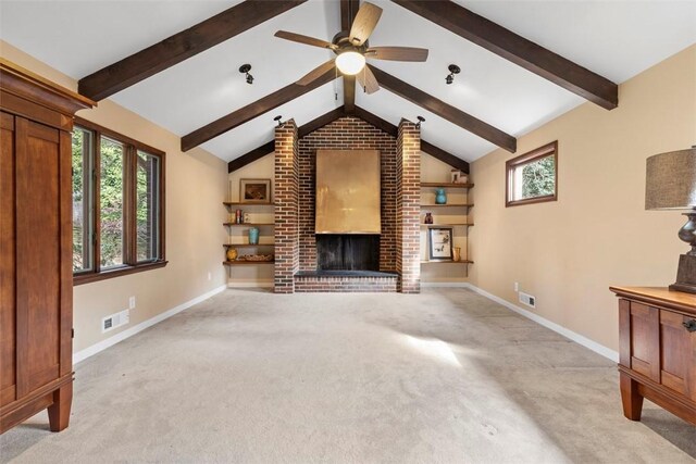 unfurnished living room with ceiling fan, vaulted ceiling with beams, light colored carpet, and a fireplace