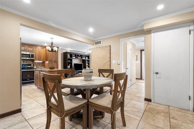 tiled dining room featuring crown molding and a chandelier